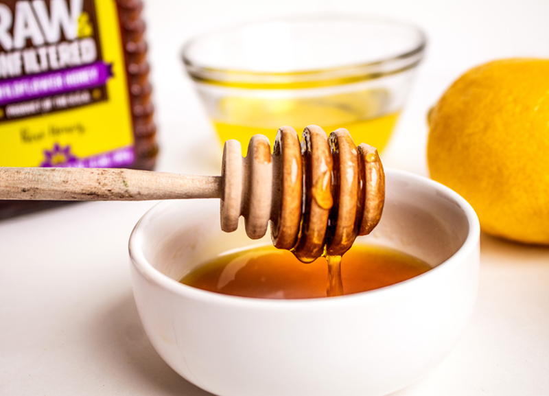 Photo of Aunt Sue's® Raw & Unfiltered Honey and lemon and oil mixture.