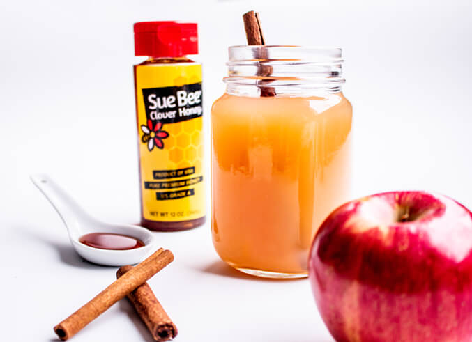 Photo of Sue Bee® honey and apple cider.