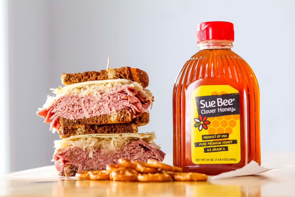 Photo of Honey-Glazed corned Beef sandwich and SUE BEE® honey.